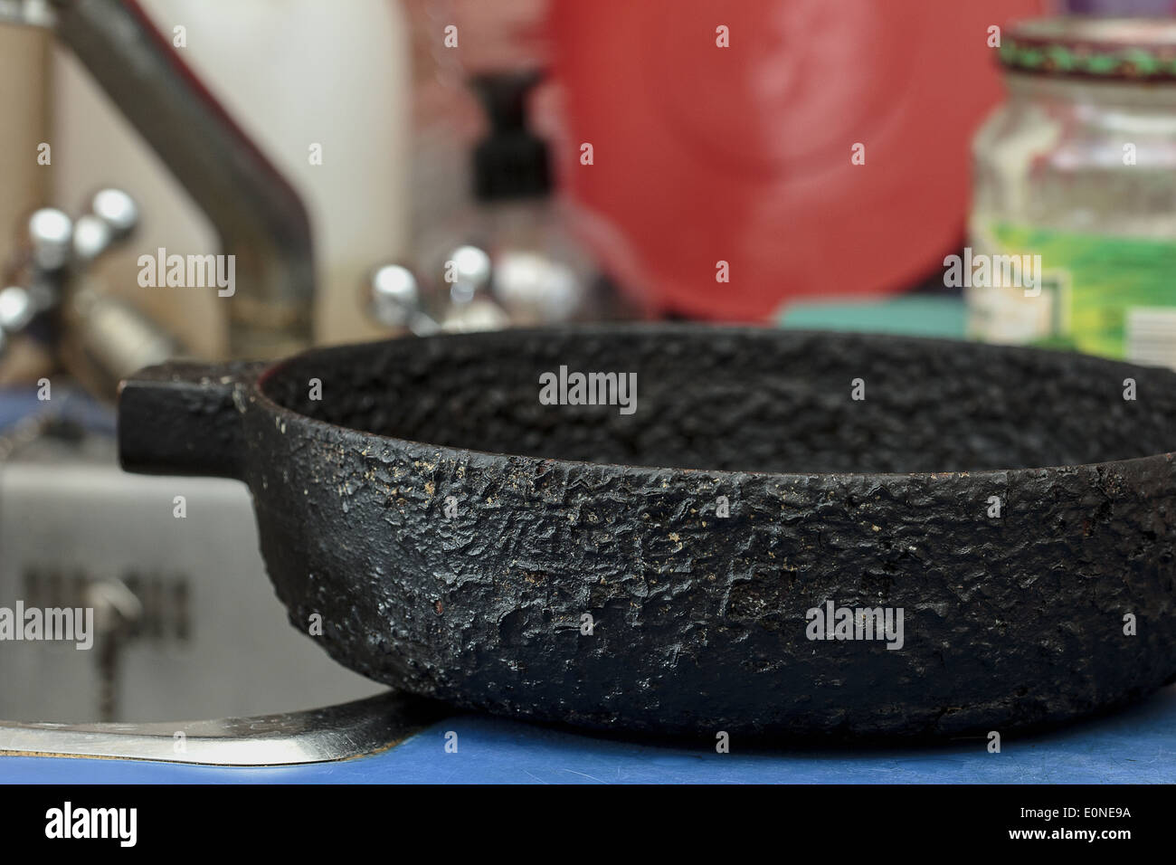Old cast iron black skillet in kitchen Stock Photo