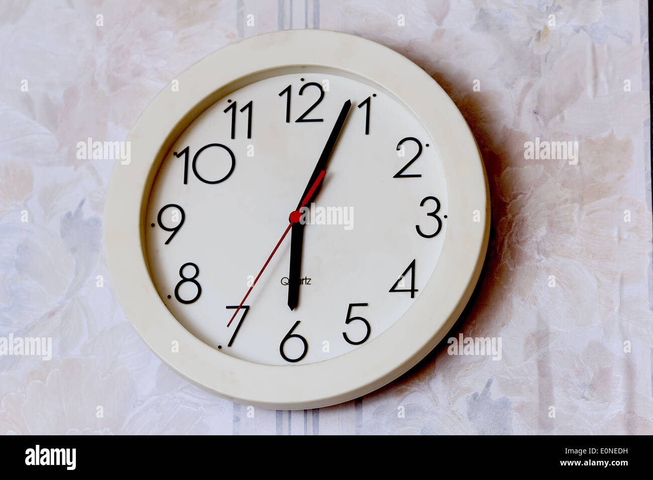 White round wall clock four minutes of seventh Stock Photo