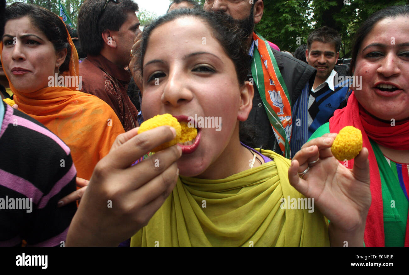 Srinagar, Indian Administered Kashmir :17 May 2014 Activists   and workers of Bhartia Janta Party (B J P ) eat sweets  after party huge win yesterday in  Lok Sabah Elections  2014  Credit:  Sofi Suhail/Alamy Live News ) Stock Photo