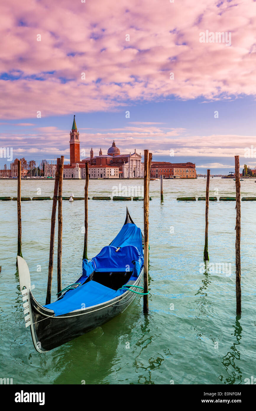 Lonely gondola tied on Grand Canal and San Giorgio Maggiore church on background in Venice, Italy (vertical composition). Stock Photo