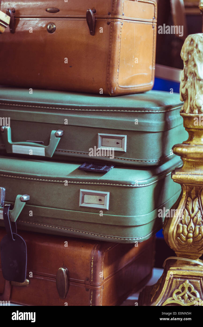 stack of brown and green leather suitcases in an attic Stock Photo Alamy