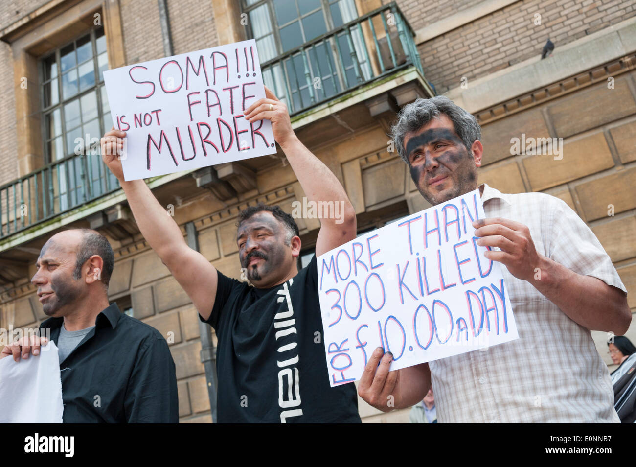 Cambridge UK 17th May 2014. People demonstrate about the mining disaster at Soma, Turkey where 301 people died after an explosion on Tuesday this week.  Around 15 people held a silent protest whilest holding placards outside the Cambridge Guildhall. Credit Julian Eales/Alamy Live News Stock Photo