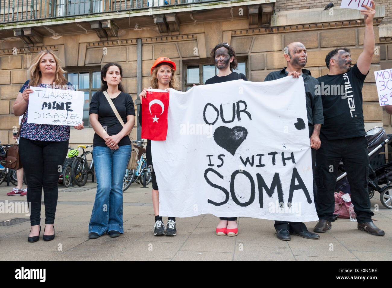 Cambridge UK 17th May 2014. People demonstrate about the mining disaster at Soma, Turkey where 301 people died after an explosion on Tuesday this week.  Around 15 people held a silent protest whilest holding placards outside the Cambridge Guildhall. Credit Julian Eales/Alamy Live News Stock Photo