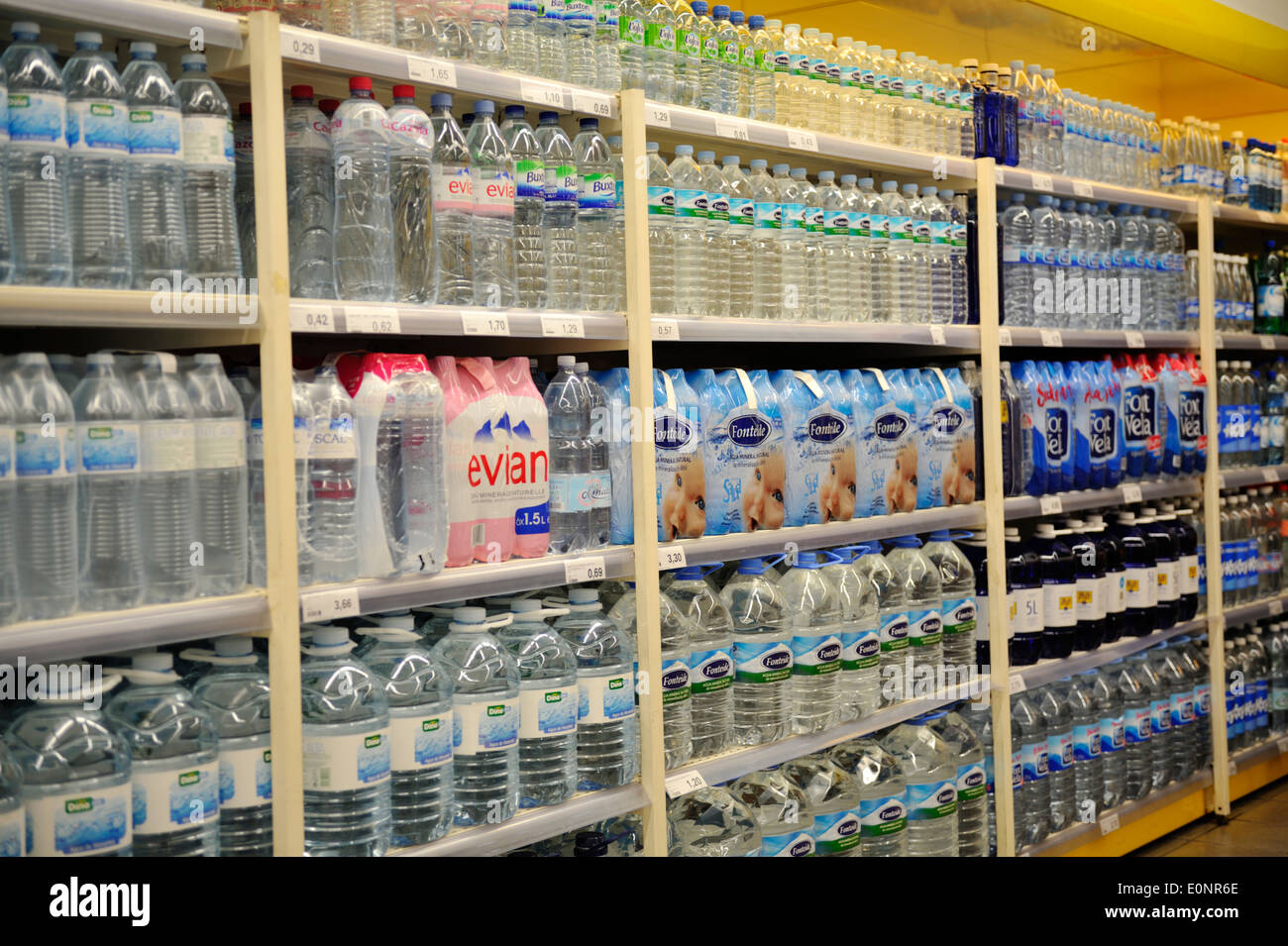 Shelves of bottled water for sale in supermarket Stock Photo Alamy