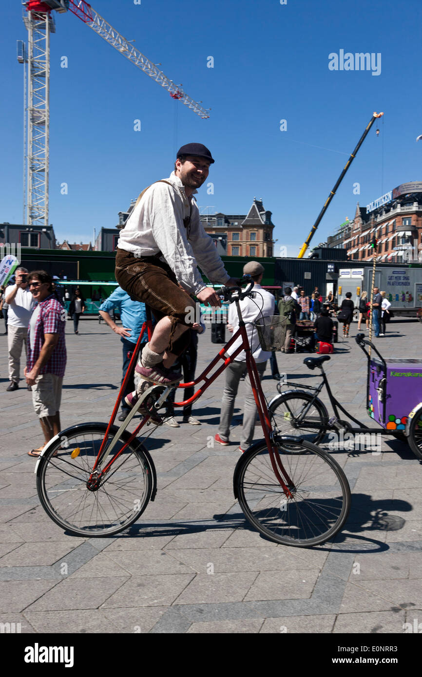 Copenhagen, Denmark. 17th May 2014. Christiania – the free town for alternative life in the middle of Copenhagen – celebrates their very own bikes 30 years anniversary, the special 3 wheeled freight bicycle, with a colorful parade through Copenhagen, staring at the town hall square and  gathering more than 200 bikes. The bikes are designed and produced in Christiania’s own workshop. The bike on the photo is an alternative version, design going back to 1843 by Michael Perdersen (inventor of the hub gears) and still produced in free town  Christiania. Credit:  OJPHOTOS/Alamy Live News Stock Photo