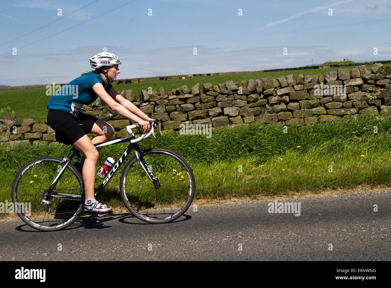 Woman in black shorts riding Scott bike at Pately Bridge, Nidderdale, Yorkshire, UK. 17th May 2014:  Otley Sportive Cycling Organisation hosting their first women only sportive.  The Sportiva offered participants the choice of two routes – a medium, 40 kilometre ride from Pool to Harrogate then Wetherby, and back, and a longer, 100 kilometre ride that will take in Pateley Bridge, Knaresborough and Wetherby. Stock Photo