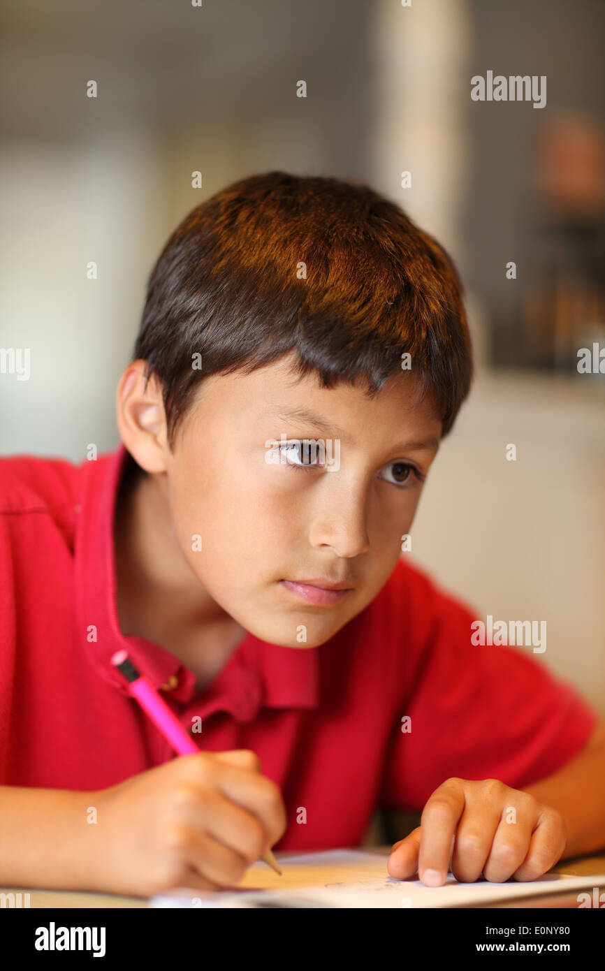 Young boy drawing for his homework - shallow depth of field Stock Photo