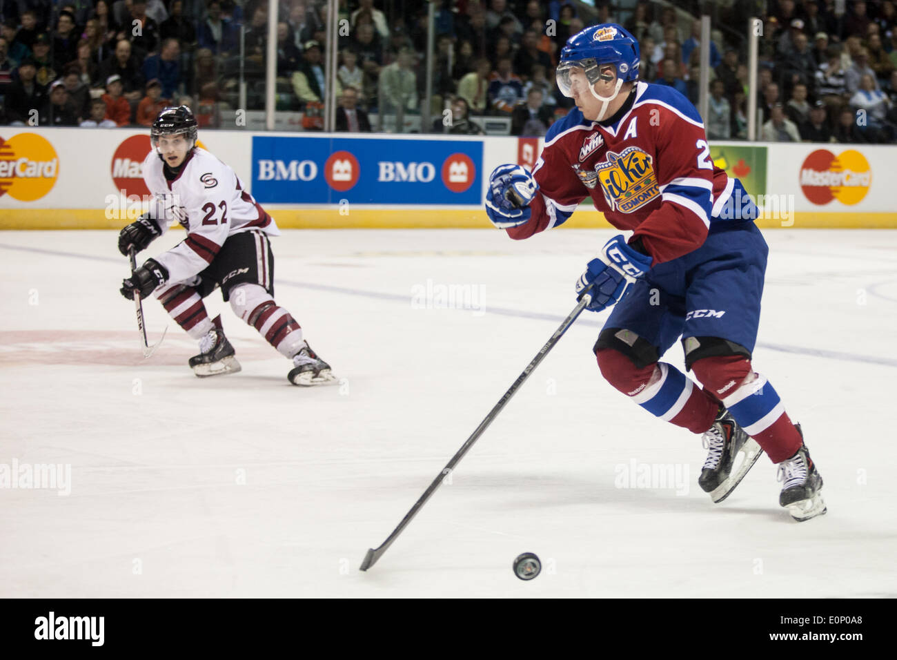 London, Ontario, Canada. 17th May, 2014. Chris Lazar (27) of the Edmonton Oil Kings carries the puck while be watched by Pius Suter of the Guelph Storm during their 2014 Memorial Cup game played at Budweiser Gardens in London Ontario, Canada on May 17, 2014.  The Guelph Storm defeated the Edmonton Oil Kings by a score of 5-2. Credit:  Mark Spowart/Alamy Live News Stock Photo