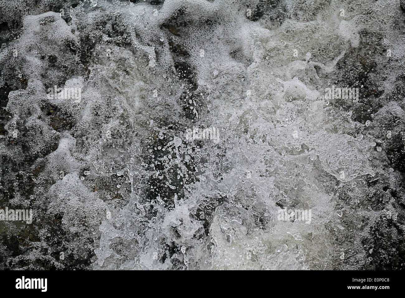 foaming water flowing over rocks, St Ives, Cornwall Stock Photo