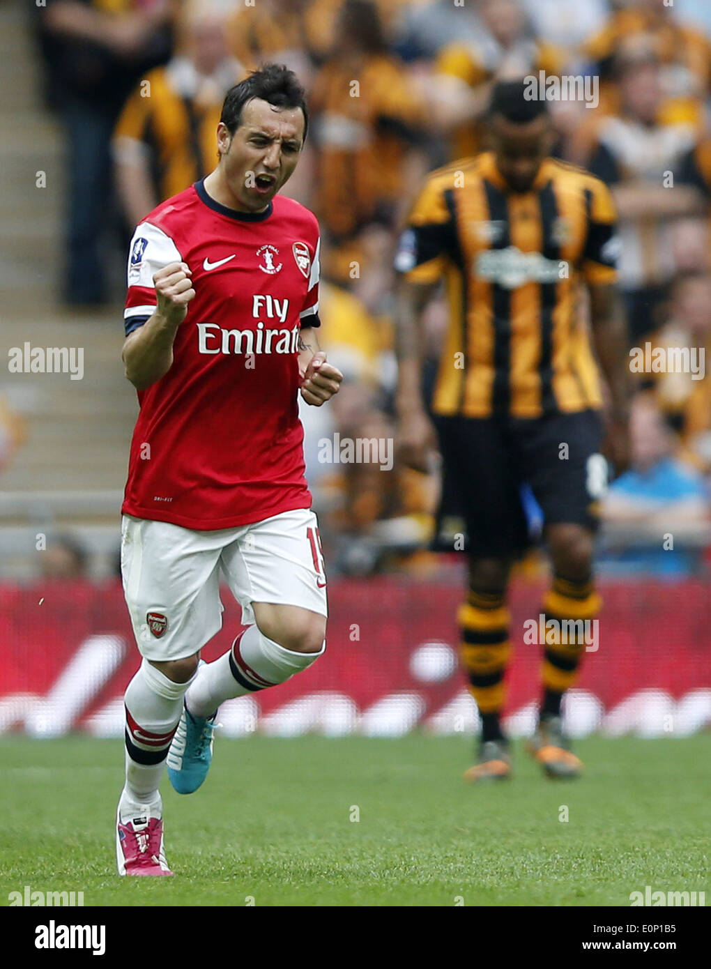 London, Britain. 17th May, 2014. Santi Cazorla (L) of Arsenal celebrates scoring during FA Cup final between Arsenal and Hull City at Wembley Stadium in London, Britain, on May 17, 2014. Arsenal ended nine-year wait for a trophy by beating Hull City with 3-2. Credit:  Wang Lili/Xinhua/Alamy Live News Stock Photo