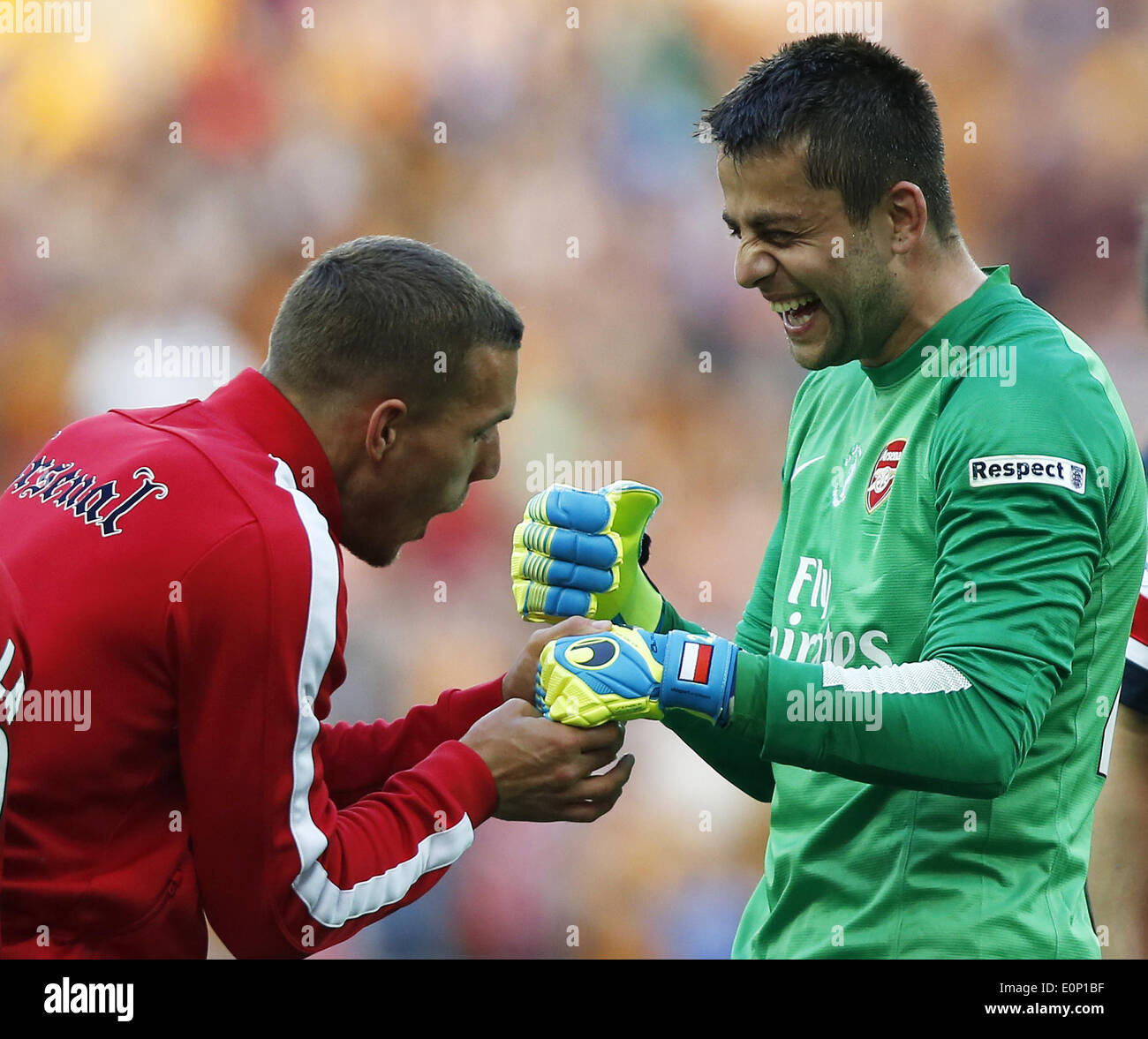 London, Britain. 17th May, 2014. Arsenal's Lukas Podolski (L) celebrates with goalie Lukasz Fabianski after FA Cup final between Arsenal and Hull City at Wembley Stadium in London, Britain, on May 17, 2014. Arsenal ended nine-year wait for a trophy by beating Hull City with 3-2. Credit:  Wang Lili/Xinhua/Alamy Live News Stock Photo