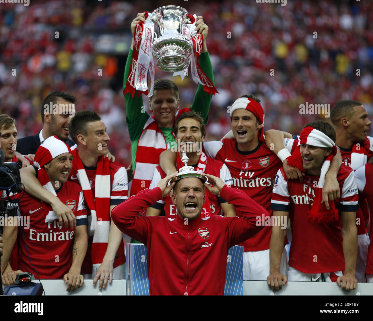 London, Britain. 17th May, 2014. Lukas Podolski (Front) of Arsenal celebrates after FA Cup final between Arsenal and Hull City at Wembley Stadium in London, Britain, on May 17, 2014. Arsenal ended nine-year wait for a trophy by beating Hull City with 3-2. Credit:  Wang Lili/Xinhua/Alamy Live News Stock Photo