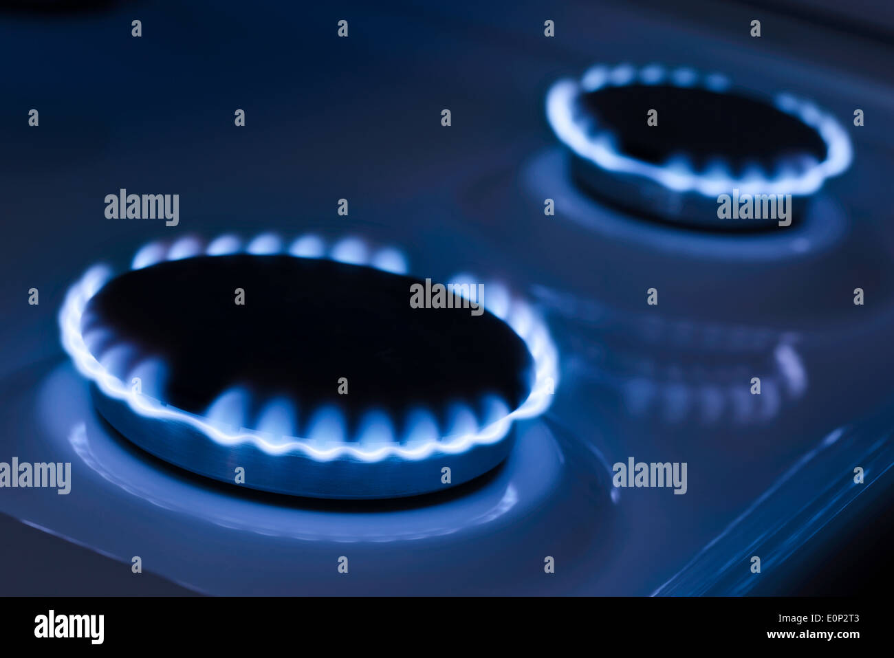 The blue flame from the burner of a gas stove Stock Photo