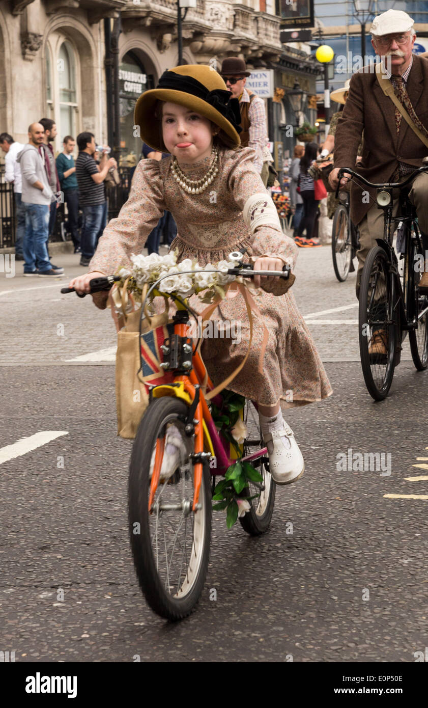 London, UK. 17th May, 2014. Cyclists pedaling during the Tweed Run on Saturday, 17 May 2014, London, UK. The London Tweed Run is a ten-mile charity bicycle organized in aid of the London Cycling Campaign where riders togged up to the nines in 1920s and 1930s cycling gear pedal around iconic London locations. Credit:  Cecilia Colussi/Alamy Live News Stock Photo