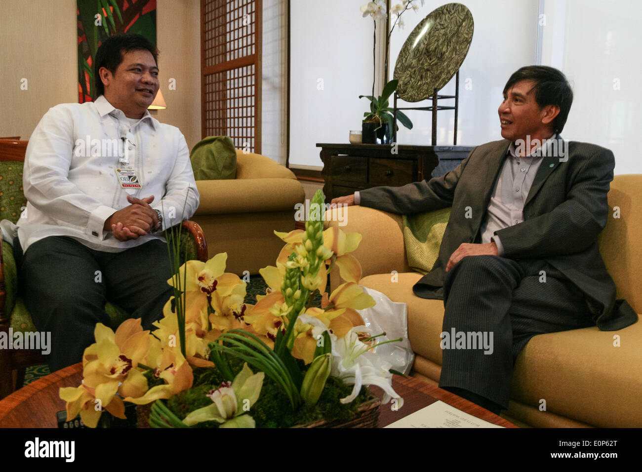 MANILA, PHILIPPINES - MAY 18: Vietnamese Vice Minister of Finance Truong Chi Trung (R) and Philippine Department of Finance International Policy Offices Director, Jun C. Runas chat at the VIP Lounge of the Ninoy Aquino International Airport in Manila. As one of the most awaited representatives for the World Economic Forum, and with the recent tension against China, the Finance Vice Minister is expected to discuss current economic issues with his Philippine counterparts. (Photo by J Gerard Seguia/Pacific Press) Stock Photo