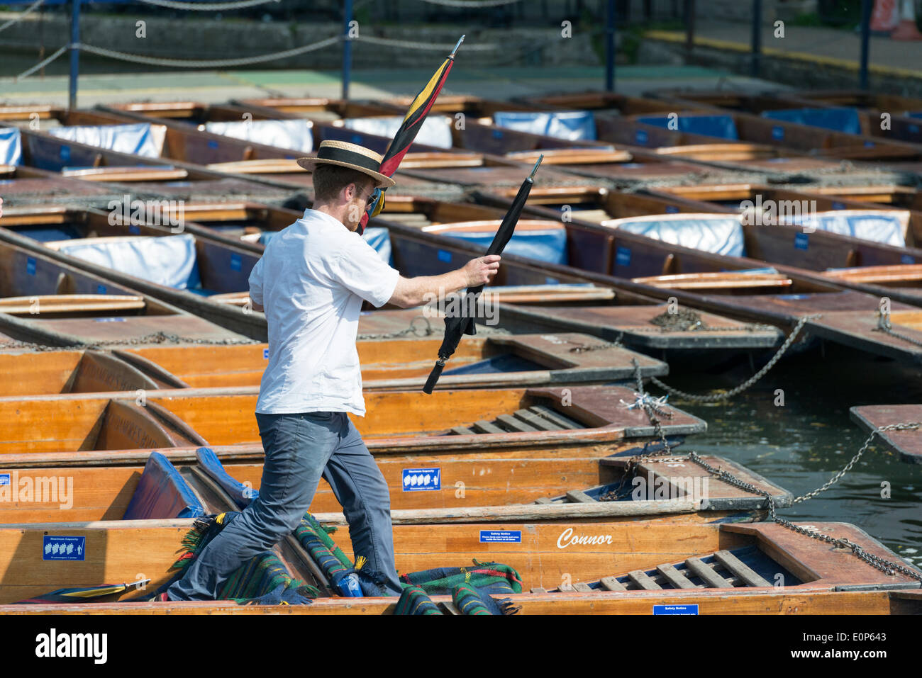 Cambridge UK , 18th May 2014. Staff at Scudamore's Boatyard prepare the punts for a busy Sunday punting on the River Cam, Cambridge UK as another warm sunny day is forecast.  The temperature is expected to reach 24 degrees centigrade.  Many tourists will take chauffeured punt trips along the river enjoying the sights of the historic University buildings.  Credit Julian Eales/Alamy Live News Stock Photo