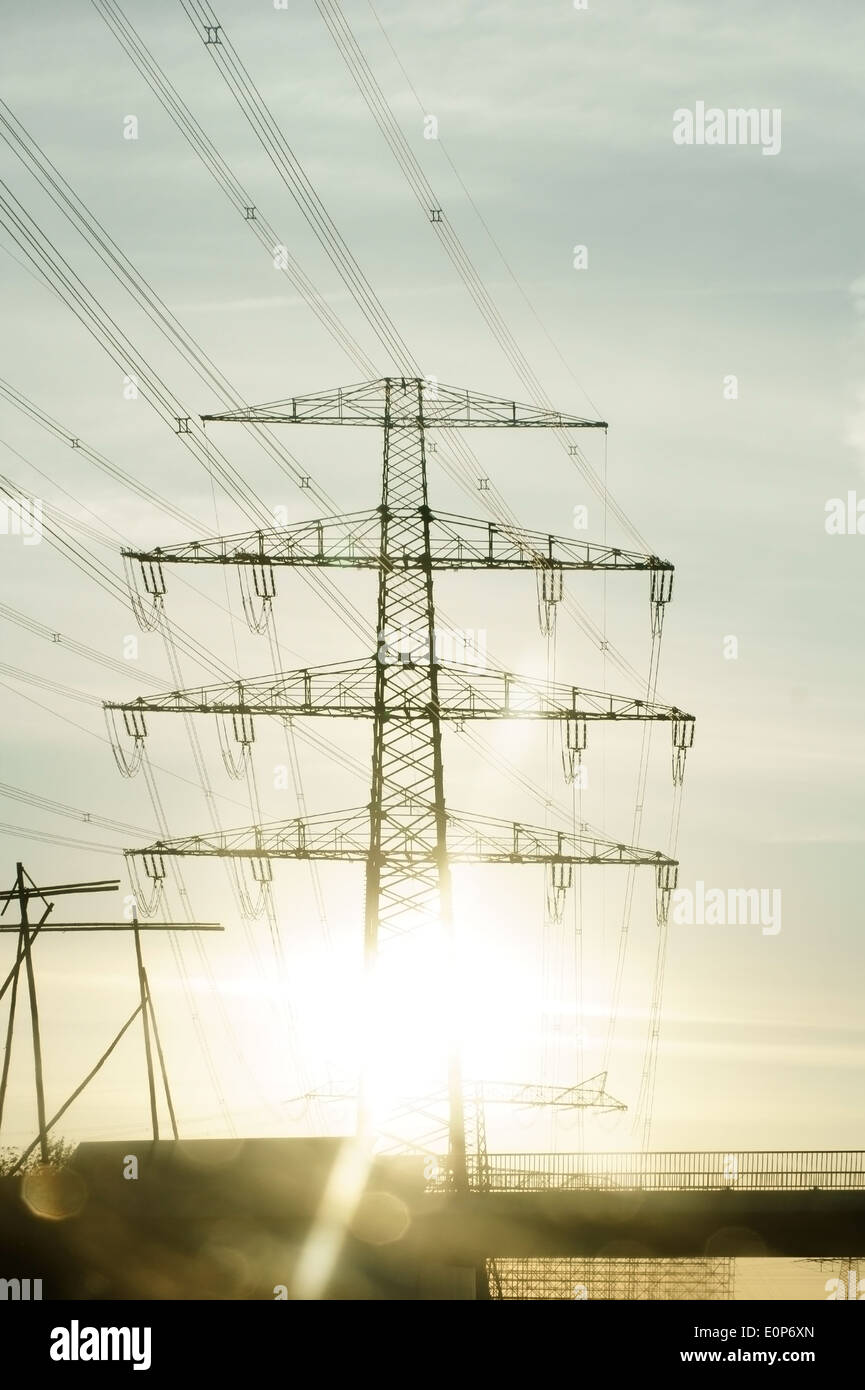 Sun rays in power pole Stock Photo