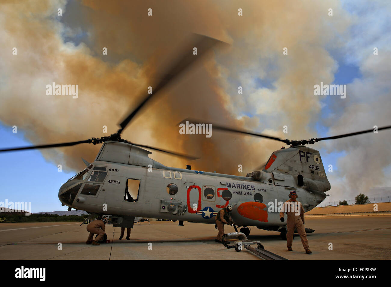 US Marines prepare a CH-46 Sea Knight helicopter to assist in firefighting as the Tomahawk wildfire continues to burn May 16, 2014 around Camp Pendleton, California.  Evacuations forced more than 13,000 people from their homes as the fire burned across San Diego County. Stock Photo