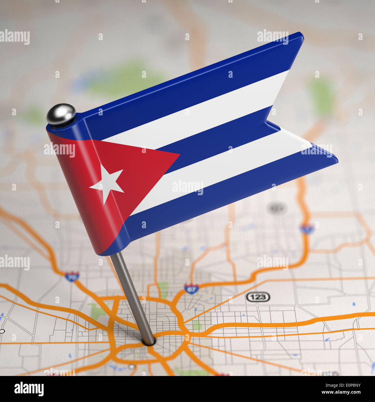 Small Flag Republic of Cuba on a Map Background with Selective Focus. Stock Photo