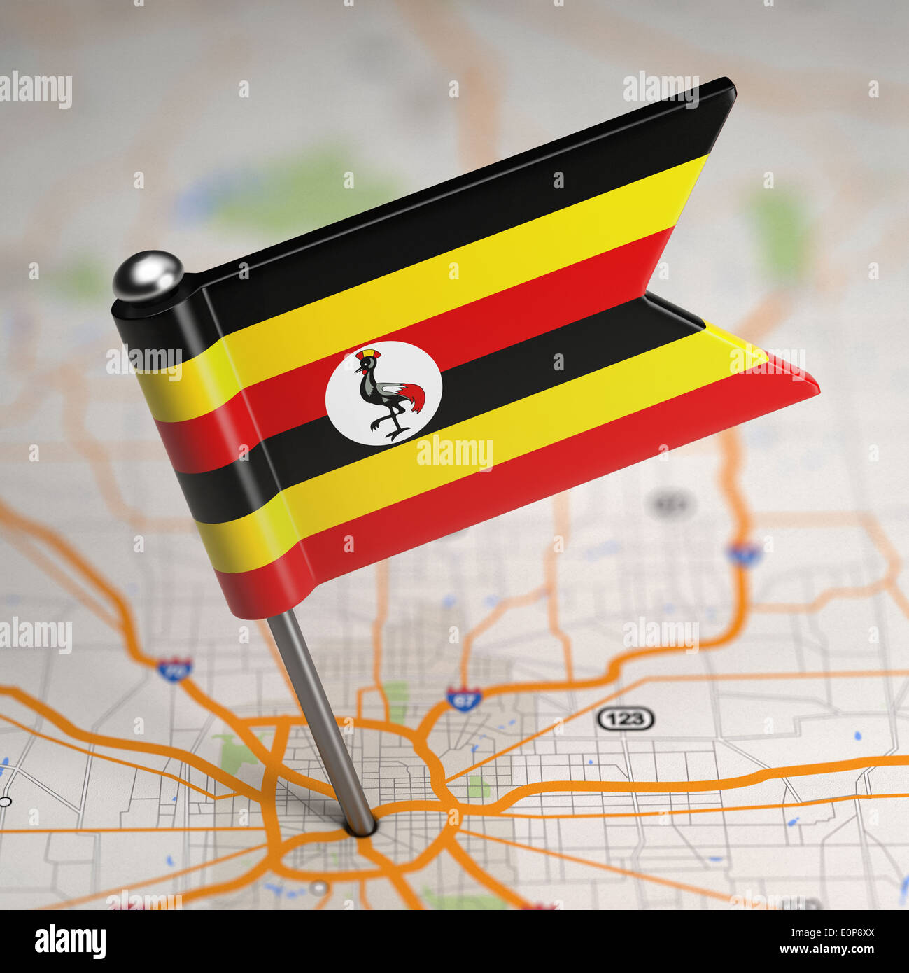 Small Flag Republic of Uganda on a Map Background with Selective Focus. Stock Photo