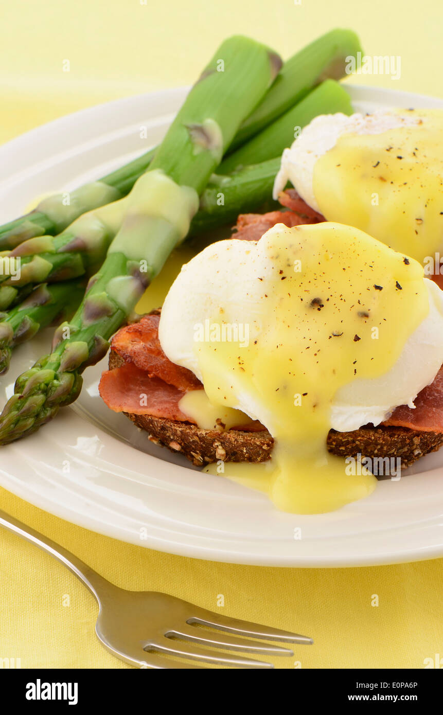 Eggs Benedict with hollandaise sauce on hearty multigrain toast with