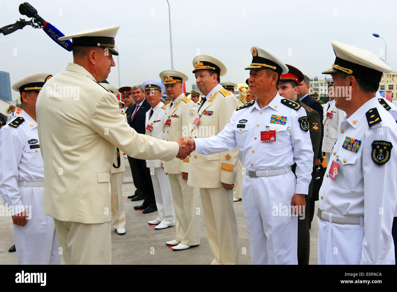 Shanghai, China. 18th May, 2014. Tian Zhong (2nd R), deputy commander of the Chinese Navy and the Chinese director of the 'Joint Sea-2014', greets the Russian naval forces at a naval port in Shanghai, east China, May 18, 2014. Six ships from the Russian Pacific Fleet will take part in the 'Joint Sea-2014' drill in the northern part of the East China Sea between May 20 and 26. A total of 14 surface ships, two submarines, nine fixed-wing warplanes, six shipboard helicopters and two operational detachment-alphas (ODAs) have rallied in Shanghai on Sunday. Credit:  Xinhua/Alamy Live News Stock Photo