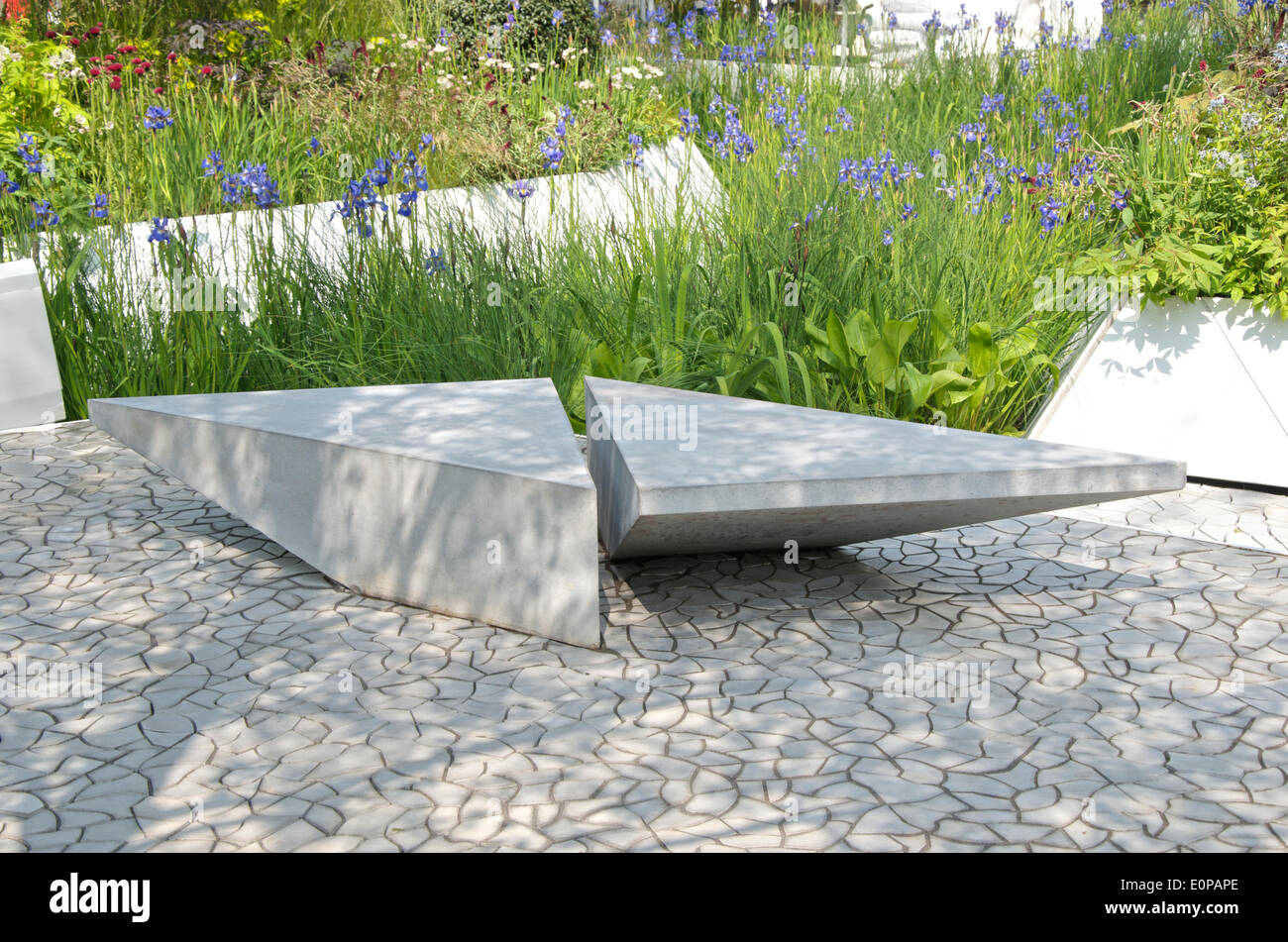 View of Iris and seating area in the The RBC Waterscape Garden at RHS Chelsea Flower Show. The garden designed by Hugo Bugg and sponsored by the Royal Bank of Canada, shows how water can be used in a sustainable way. The garden was awarded a gold medal. Stock Photo