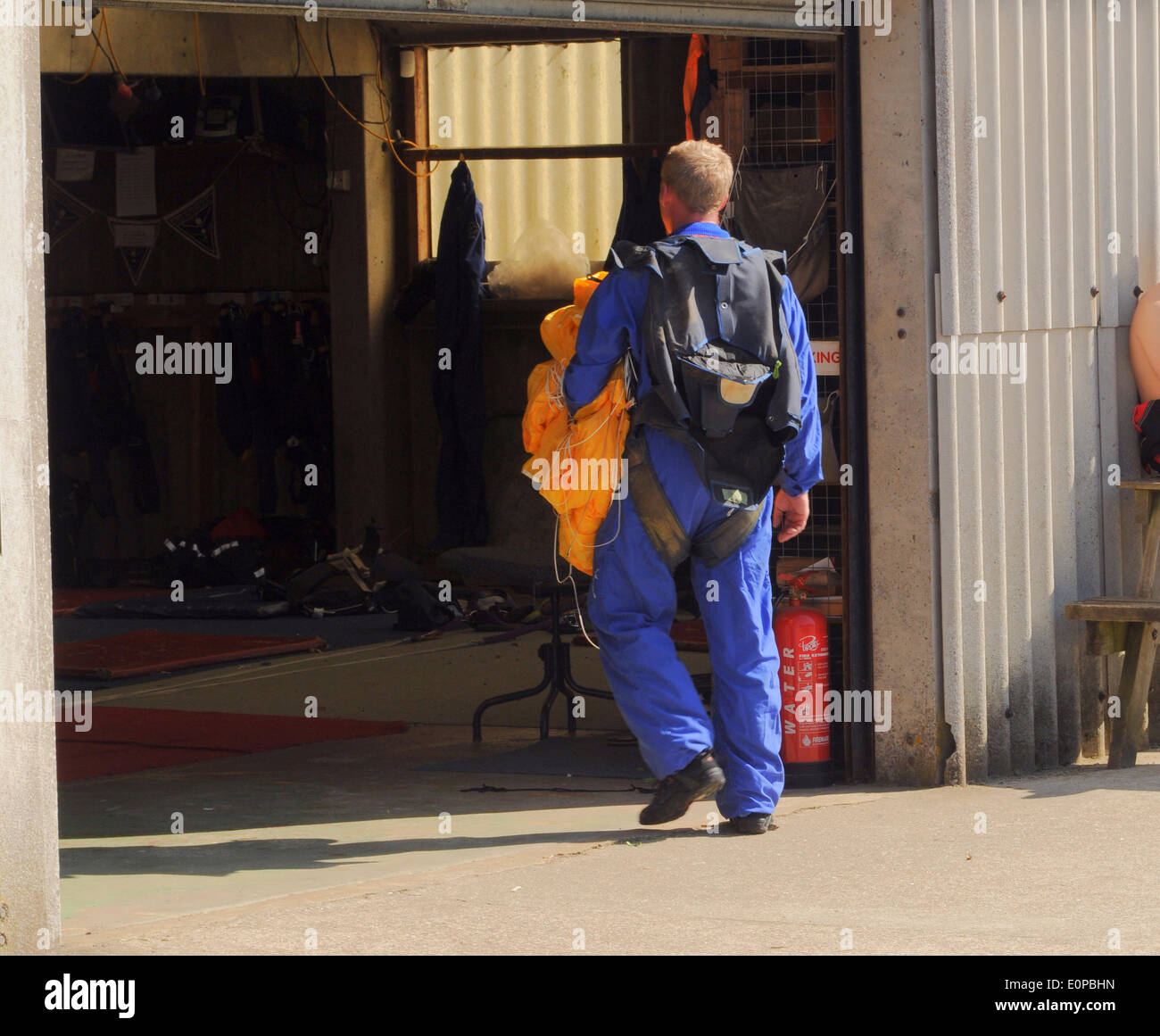 Headcorn, Kent, UK,18th May 2014.Proof that intense training works as parachutist, Luke Jordan, walks back to the hangar carrying his emergency chute.During Lukes fifth static line jump a  malfunction caused him to abandon the main chute and open his emergency chute for safe descent. David Burr/Alamy Live News Stock Photo