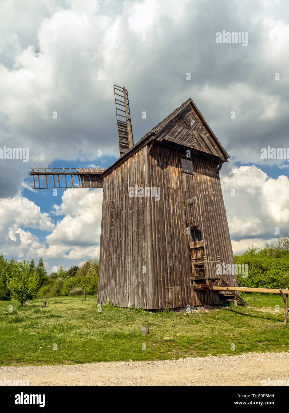 Old wooden windmill against blue sky Stock Photo