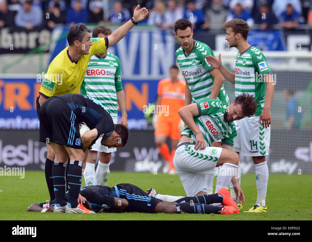 Fuerth, Germany. 18th May, 2014. Hamburg's Johan Djourou lies on the ground with an injury during the second leg relegation match between Hamburger SV and SpVgg Greuther Fuerth at Trolli Arena in Fuerth, Germany, 18 May 2014. Photo: DAVID EBENER/DPA (ATTENTION: Due to the accreditation guidelines, the DFL only permits the publication and utilisation of up to 15 pictures per match on the internet and in online media during the match.)/dpa/Alamy Live News Stock Photo