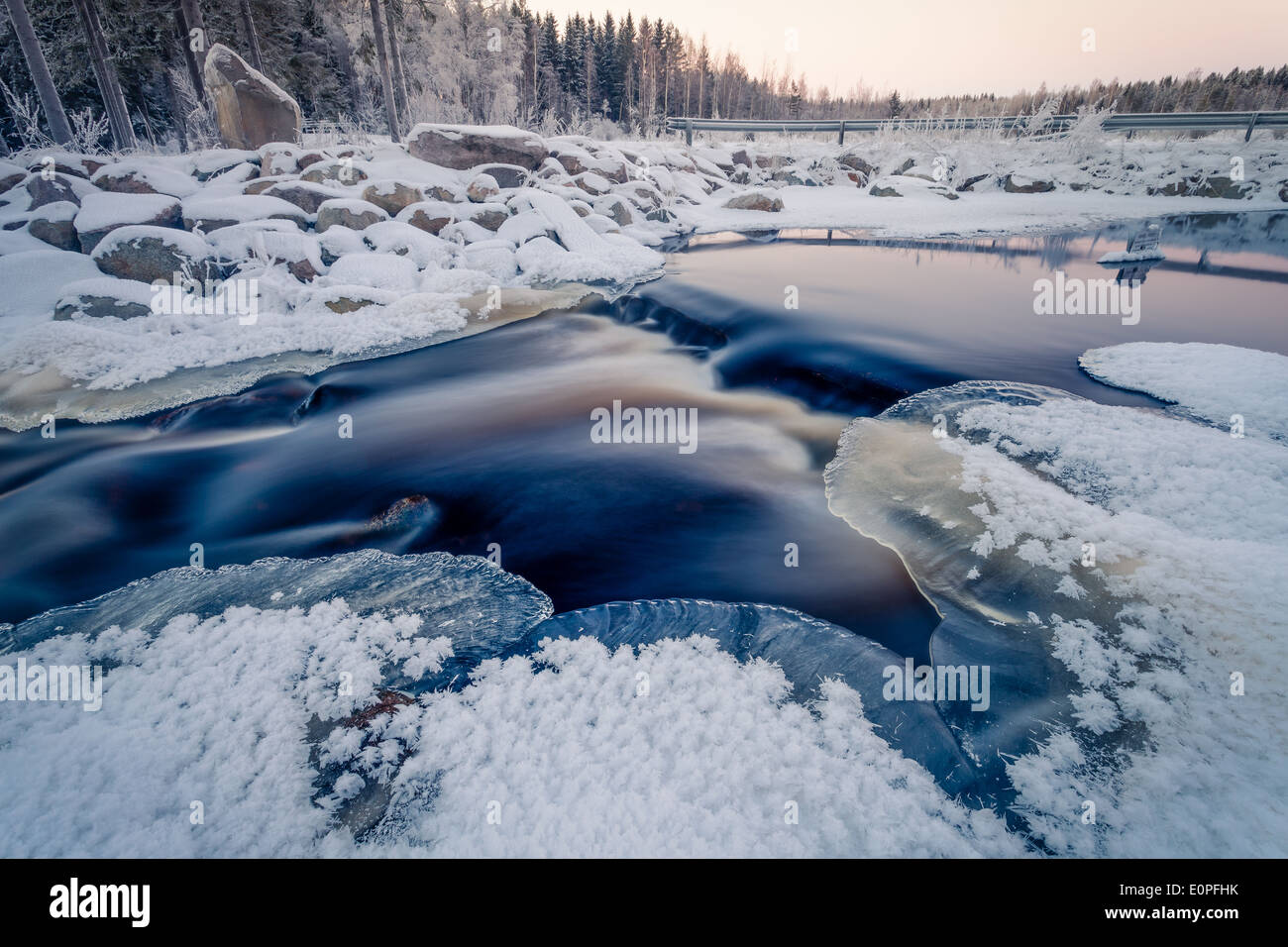 Beautiful colors of the sunset on the river in winter. Stock Photo