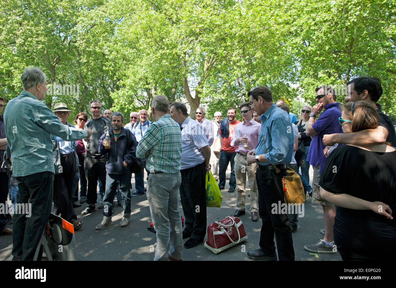 People listen to a speaker at Speakers Corner, Hyde Park, London Stock