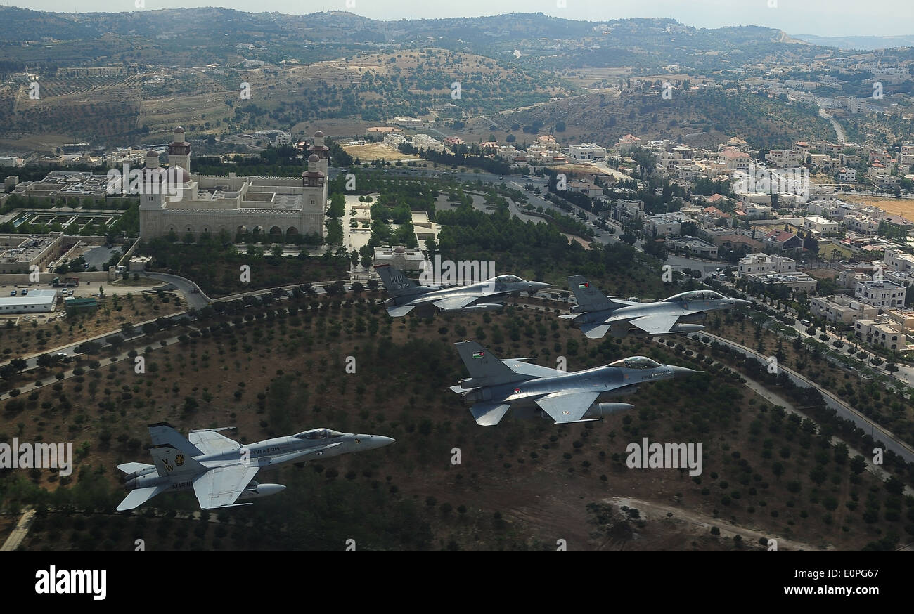 US and Royal Jordanian Air Force F-16 Fighting Falcons and a US Marine Corps F-18 Hornet fighter aircraft fly in formation the King Hussein Bin Talal Mosque during Exercise Eager Tiger May 13, 2014 in Amman, Jordan. Stock Photo