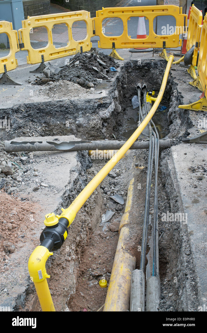 Trench in road to allow repair to gas main in Settle, north Yorkshire, England, UK Stock Photo