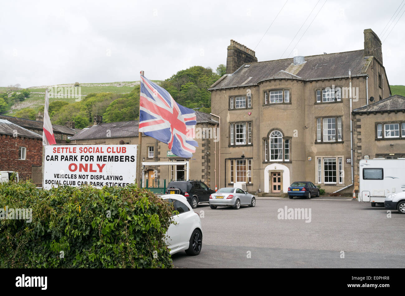 Flags flying outside Settle social club, members only north Yorkshire, England, UK Stock Photo
