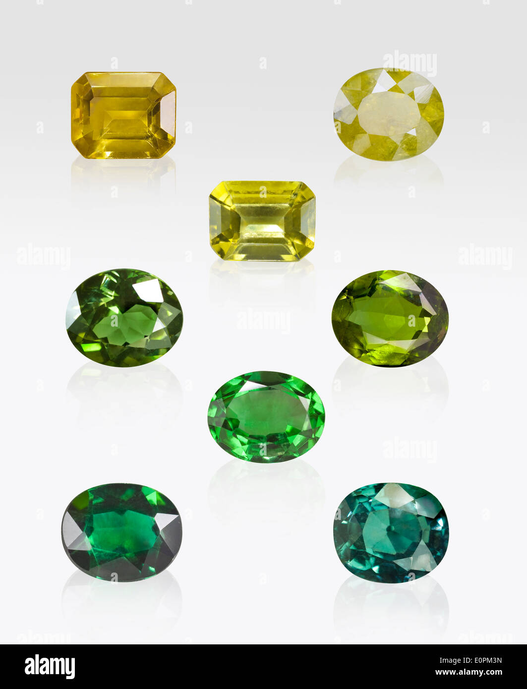 Green and Yellow tourmaline gemstones on white background Stock Photo