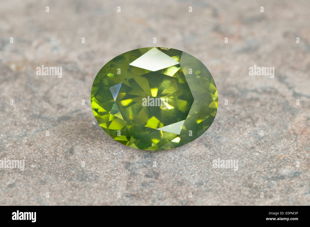 Green Zircon on granite background Stock Photo