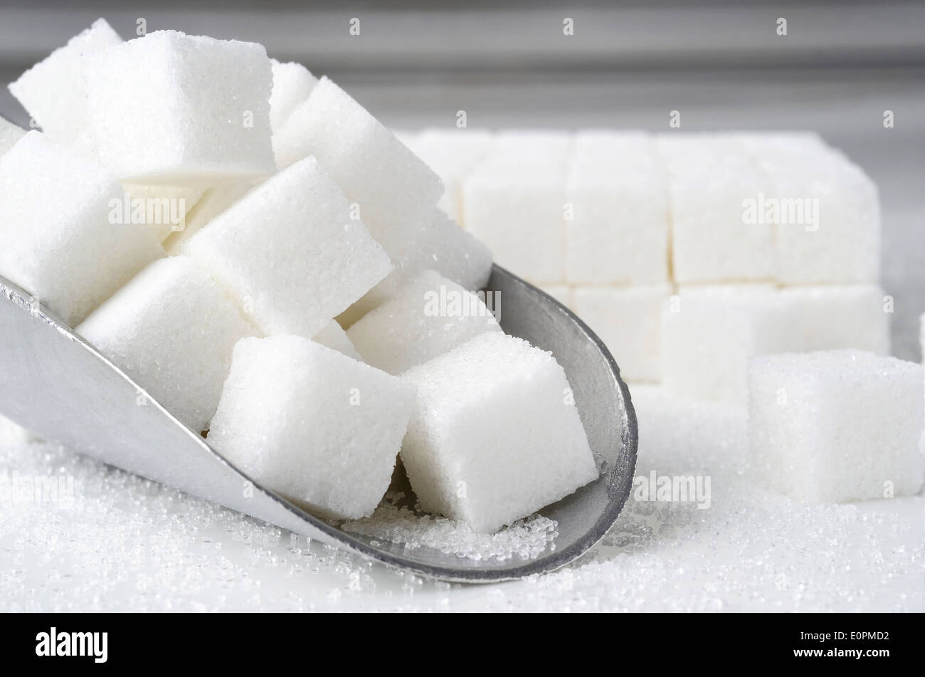 scoop of sugar cubes on white background Stock Photo