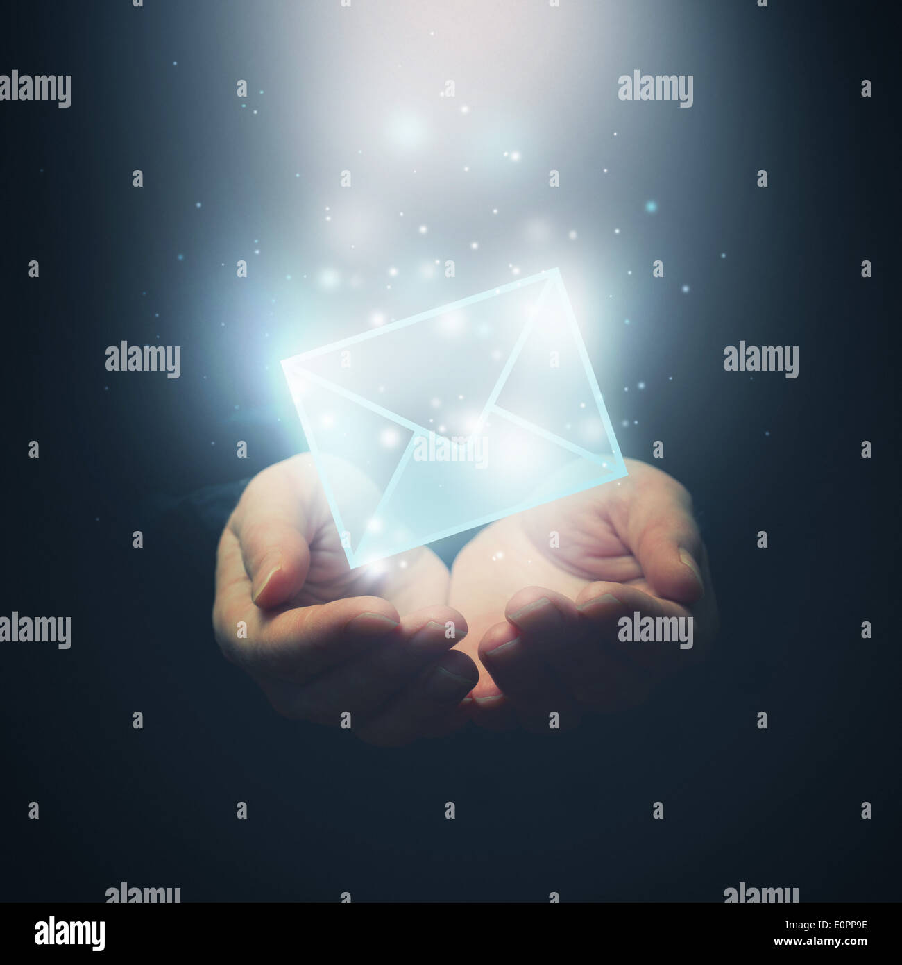 Hands with envelope. E-mail, global communications, mail or contact us concept. Selective focus on fingers. Stock Photo