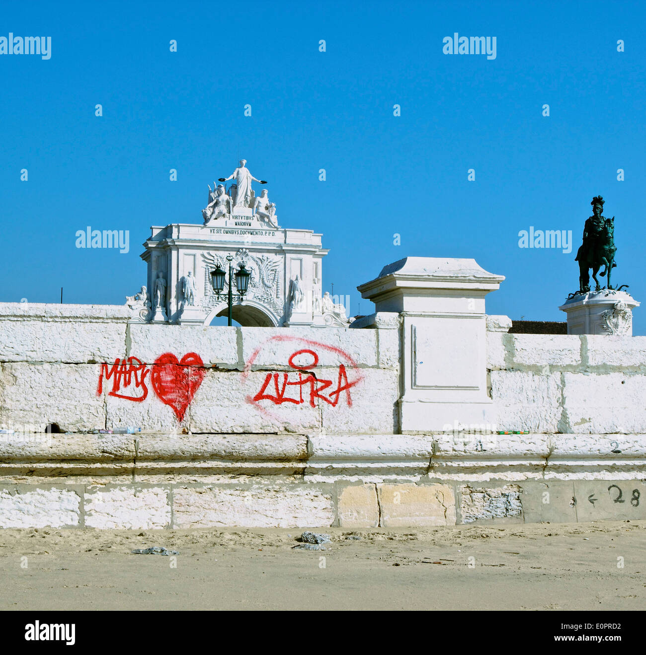 Graffiti on wall of riverfront Praca do Comercio with triumphal arch and statue of Dom Jose 1 Lisbon Portugal western Europe Stock Photo