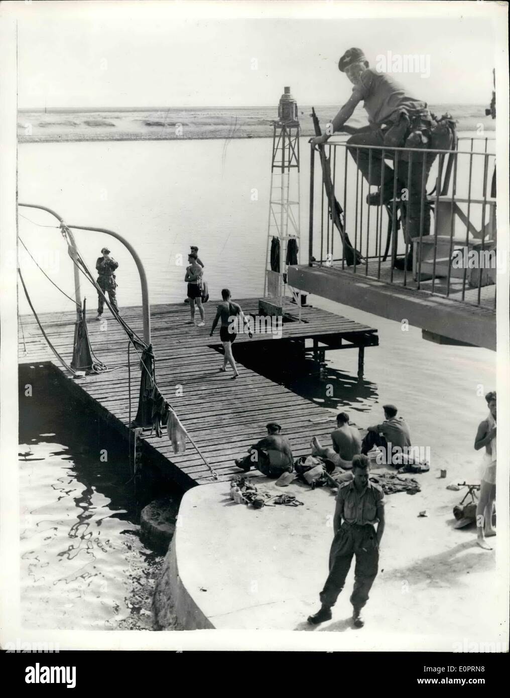 Nov. 11, 1956 - British Troops Relax - In Suez. Go for a Swim at El Capitation: Photo shows A party of British troops take a swim at El Capitation - station of the Suez Canal Company - while one of their number keeps a wary look our for snipers - during the lull between capture of the Suez area by British and French Troops - and the taking over by Uno Police Force. Stock Photo