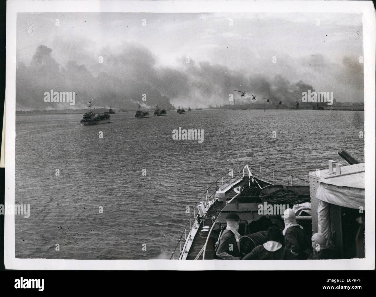 Nov. 11, 1956 - With the British Forces in Port Said.Pictures Just Received in London: This Picture just received in London today (Monday), shows helicopters carrying troops fly over landing craft approaching Port said. Stock Photo