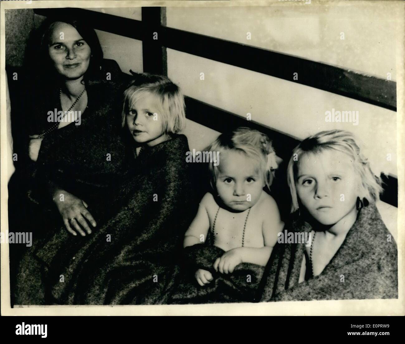 Nov. 11, 1956 - Hungarian Refugees Arrive In Switzerland.: Some 200 Hungarian refugees - mainly whole families with children, arrived at the Swiss frontier on Thursday - where they are the guests of the Swiss Red Cross. Photo shows this mother from Hegyeshalem is pictured with her three children after their arrival in Switzerland. Their father died fighting against the Russians. Stock Photo