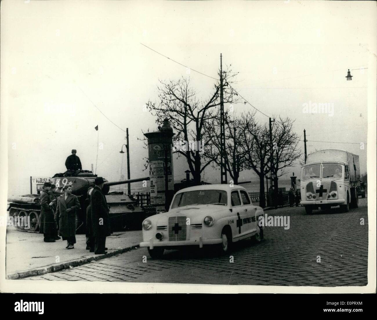 Nov. 11, 1956 - New scene from Budapest Red Cross Ambulance from the West pass Soviet Tank; Photo Shows New picture just received from Budapest - shows Red Cross Ambulance from the West on a mercy mission arriving in the City of Budapest - passing a Soviet Tank used by the Russians to crush the resistance of the Hungarian nationals. Stock Photo