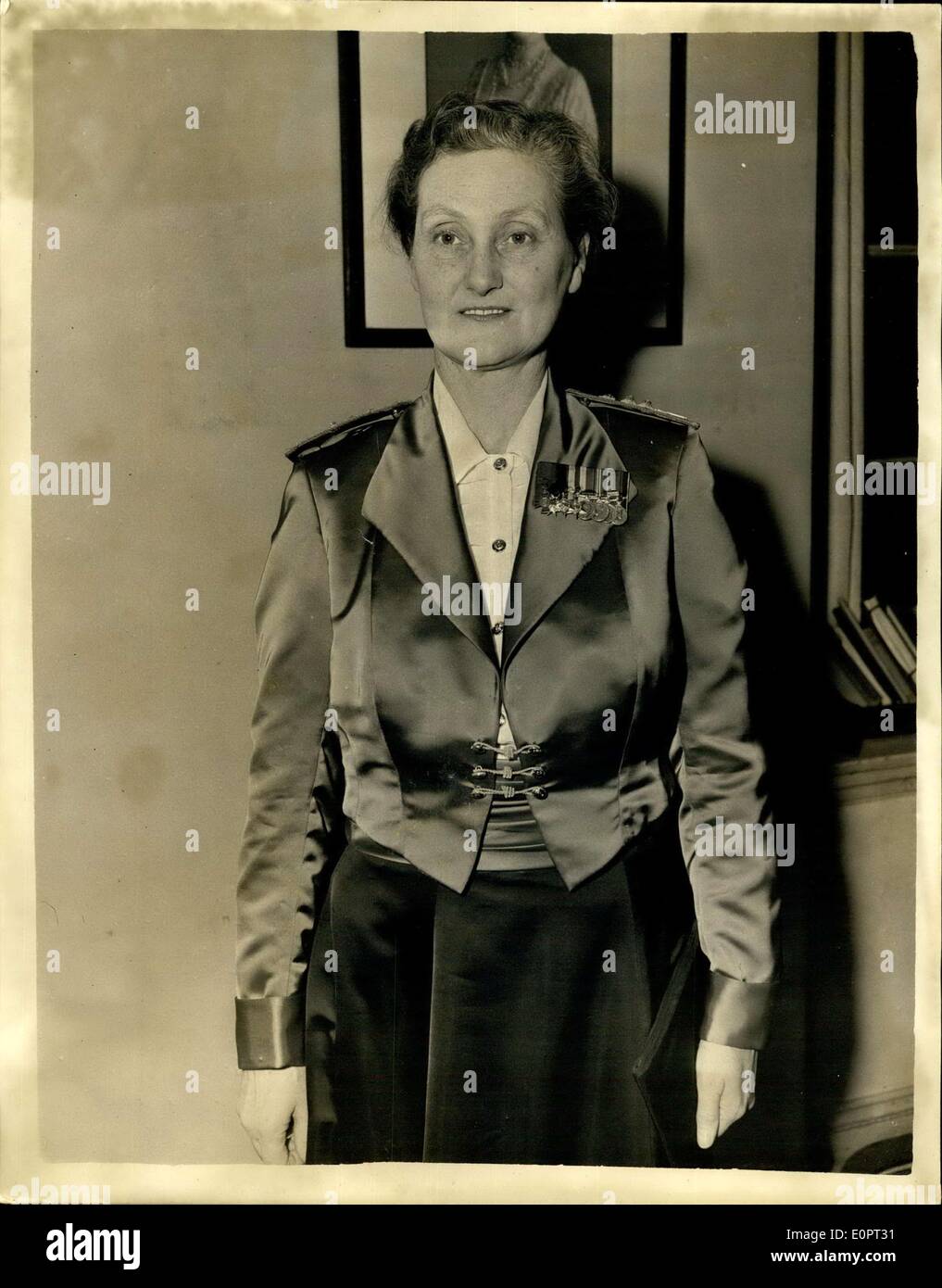 Dec. 10, 1956 - New Mess Dress For Officers Of The Queen Alexandra's Royal Army Nursing Corps.: Brigadier C.M. Johnson, RRC QHNS, Matrons in chief and Director of Army Nursing Services was to be seen at Lansdowne House this morning wearing the newly designed Mess Dress for officers-of the Queen Alexandra's Royal Army Nursing Corps..The dress consists of a black satin skirt; white Terylene Ninon blouse with long sleeves and plain tailored collar - and a scarlet jacket. Photo Shows Close-up of Brigadier C.M. Johnson in the new Mess Drwos at Landowne House this morning. Stock Photo