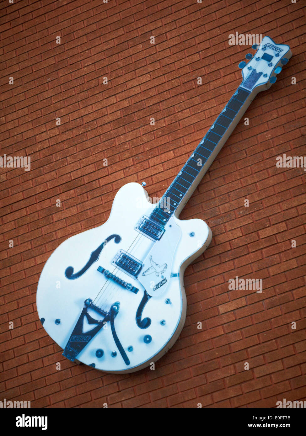 Guitar on outside wall at Dawson music store in Stockport Cheshire UK Stock Photo