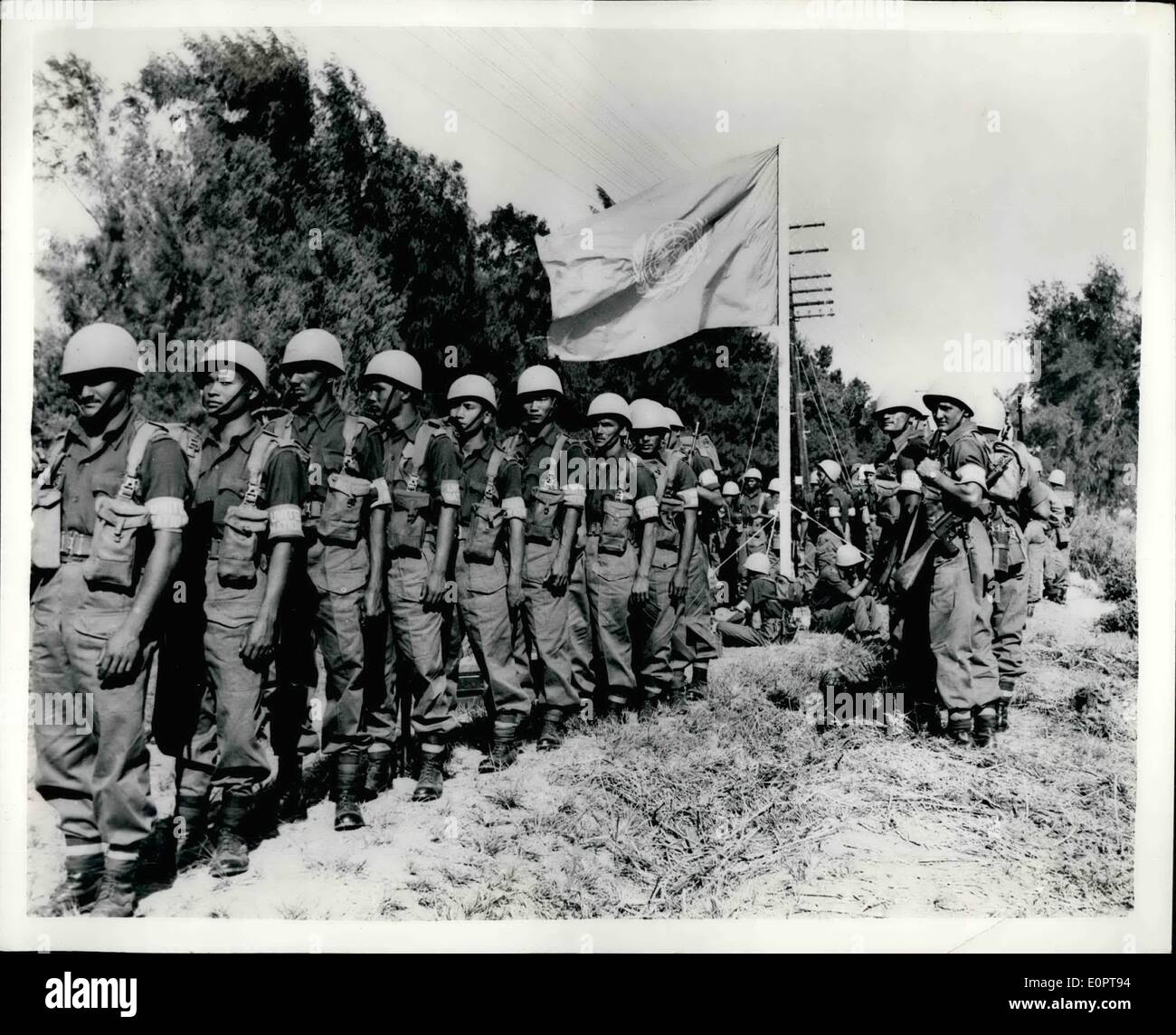 Dec. 12, 1956 - UNO SECURITY FORCE IN EGYPT. The United Nations Security Force, which is taking over from British, French and Israeli troops in the Suez Canal area, is gradually being built up With the arrival in Egypt of further contingente from the many contributing nations. PHOTO SHOWS: Indian paratroops seen forming up in front of the United Nations flag ae they prepare to take over position. In the ml Cap (Port Said) area, upon their arrival as part of the U.N.O. Security Force. Stock Photo