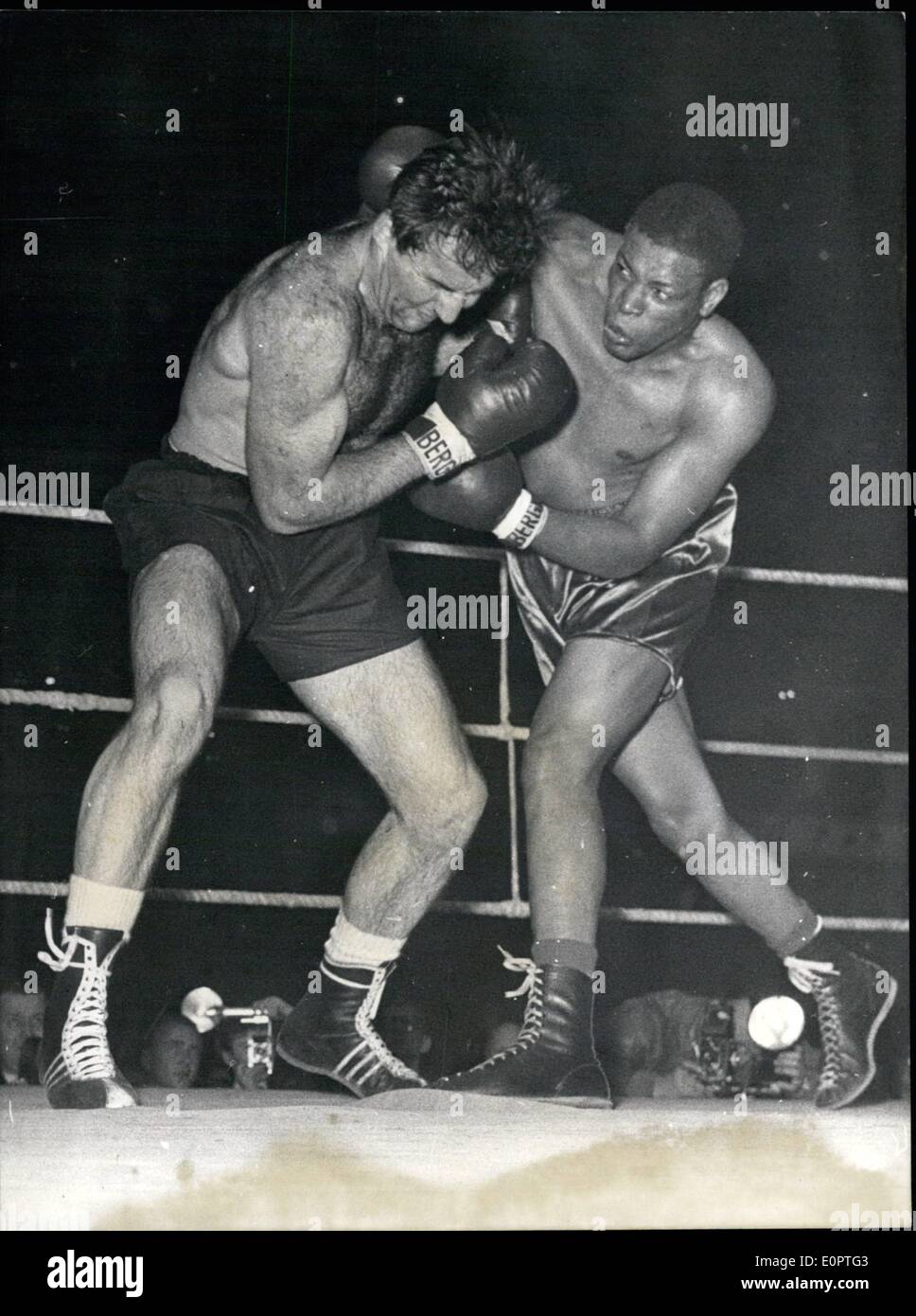 Dec. 12, 1956 - Winner by technical k.o. ... ...was on Sunday (30.12.55) the black champion from Cuba NINO VALDEZ about the german heavy wight fighter HANS FRIEDRICH in the Westfalen Halle at Dortmund. Ops.: A fight between Hans Friedrich (left) and Nino Valdez. Stock Photo