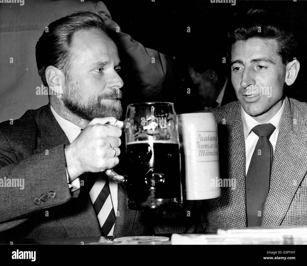 Mountaineers Fritz Moravec and Herman Buhl toast a drink Stock Photo