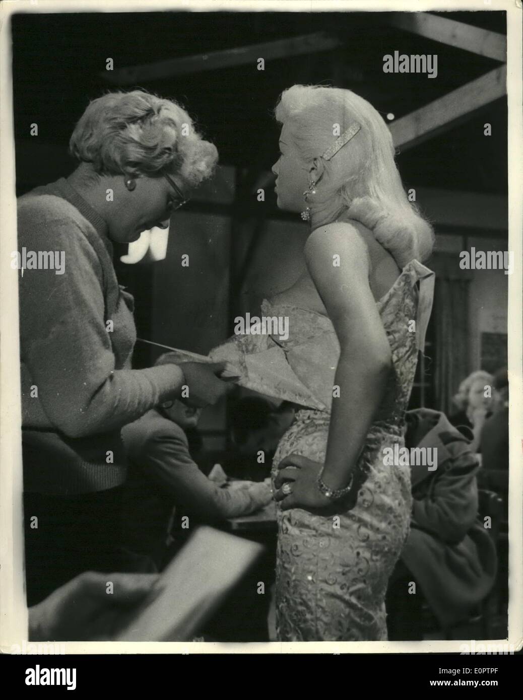 Feb. 28, 1957 - 28-2-57 The son of a Marchioness rips Diana Dors' gown from her shoulder. But it is all in a film. During the filming of the The Long Haul at Shepperton Studios yesterday, actor Patrick Allen, 30-year old son of the Marchioness of Downshire (by her first marriage) had to rip the shoulder strap of Diana Dors' evening gown during a scene in a road transport caf&eacute;. In the film Dina Dors co-stars with Victure Mature for the first time Stock Photo
